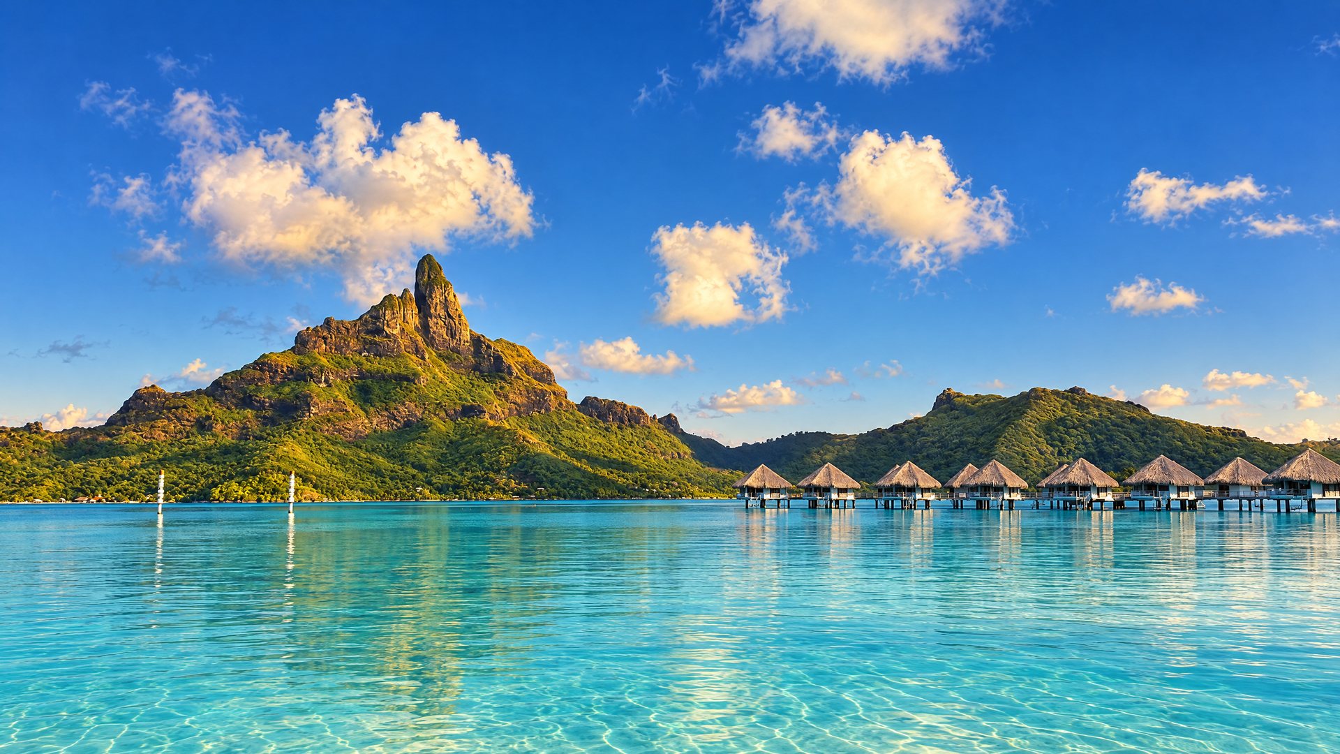 Mount Otemanu rising over the Bora Bora lagoon, with overwater bungalows on the right