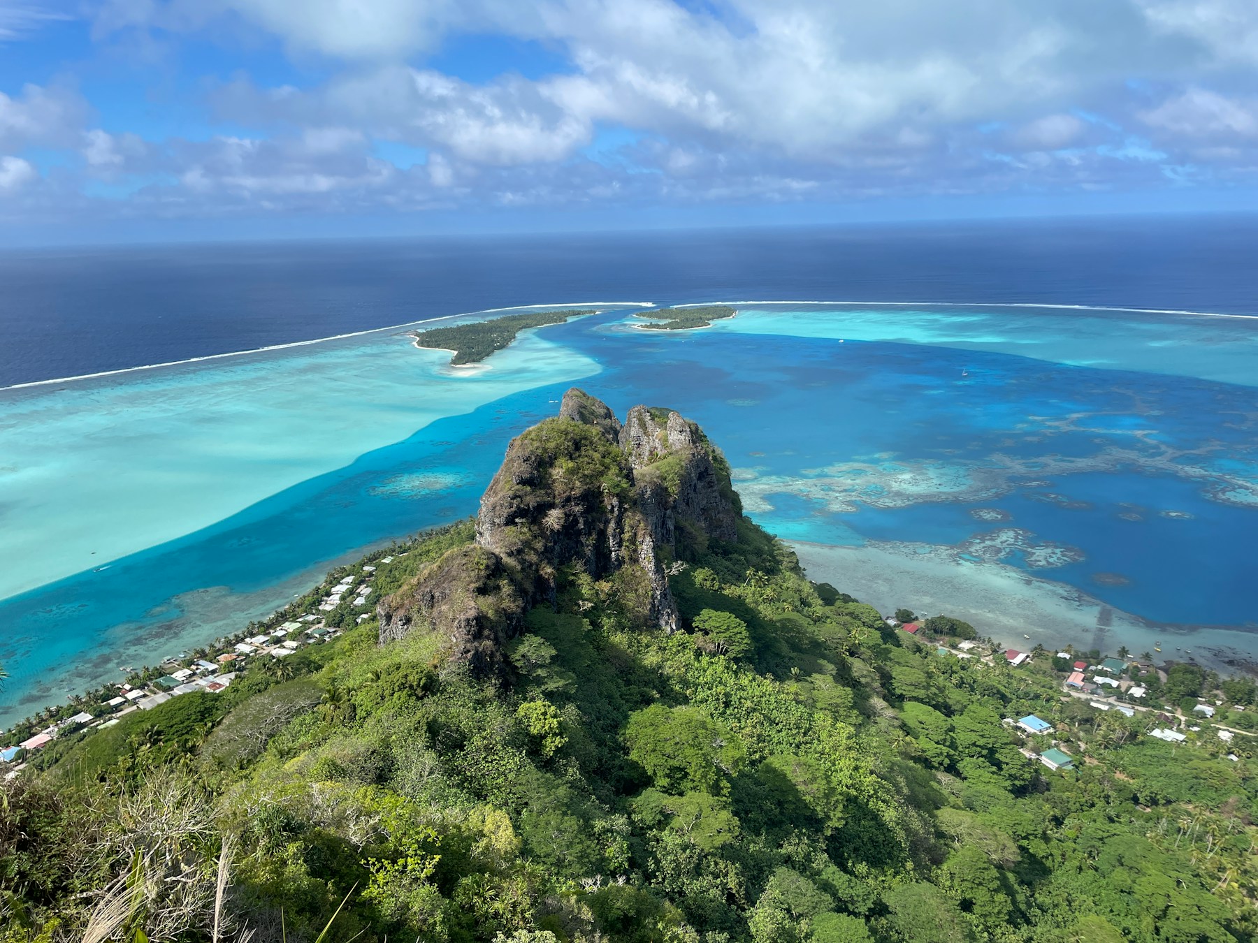 A green Tahitian landscape under a wide sky